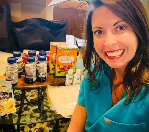 smiling woman organizing food and goods for the elderly