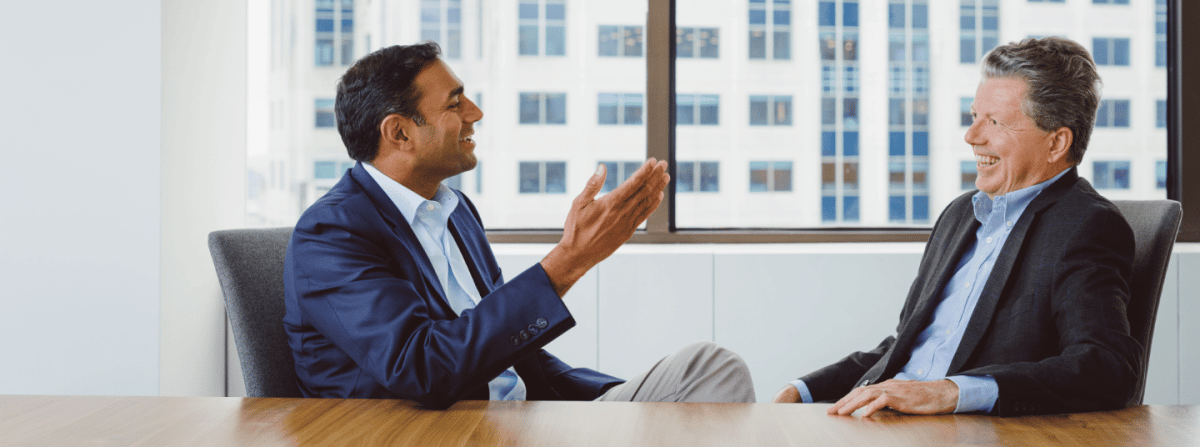 businessmen talking at conference table