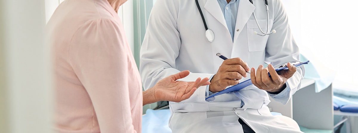 doctor and patient having discussion while taking notes